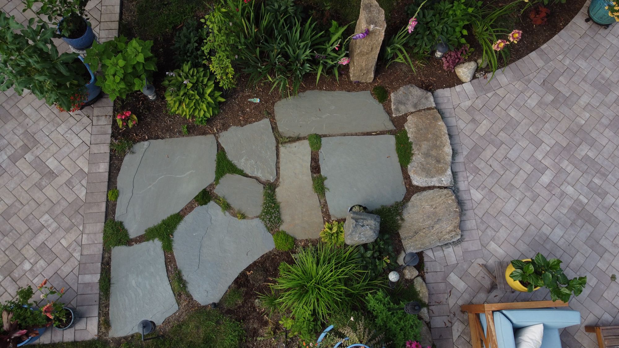 Arnold Ave project; natural stone walkway in between two paver patio areas