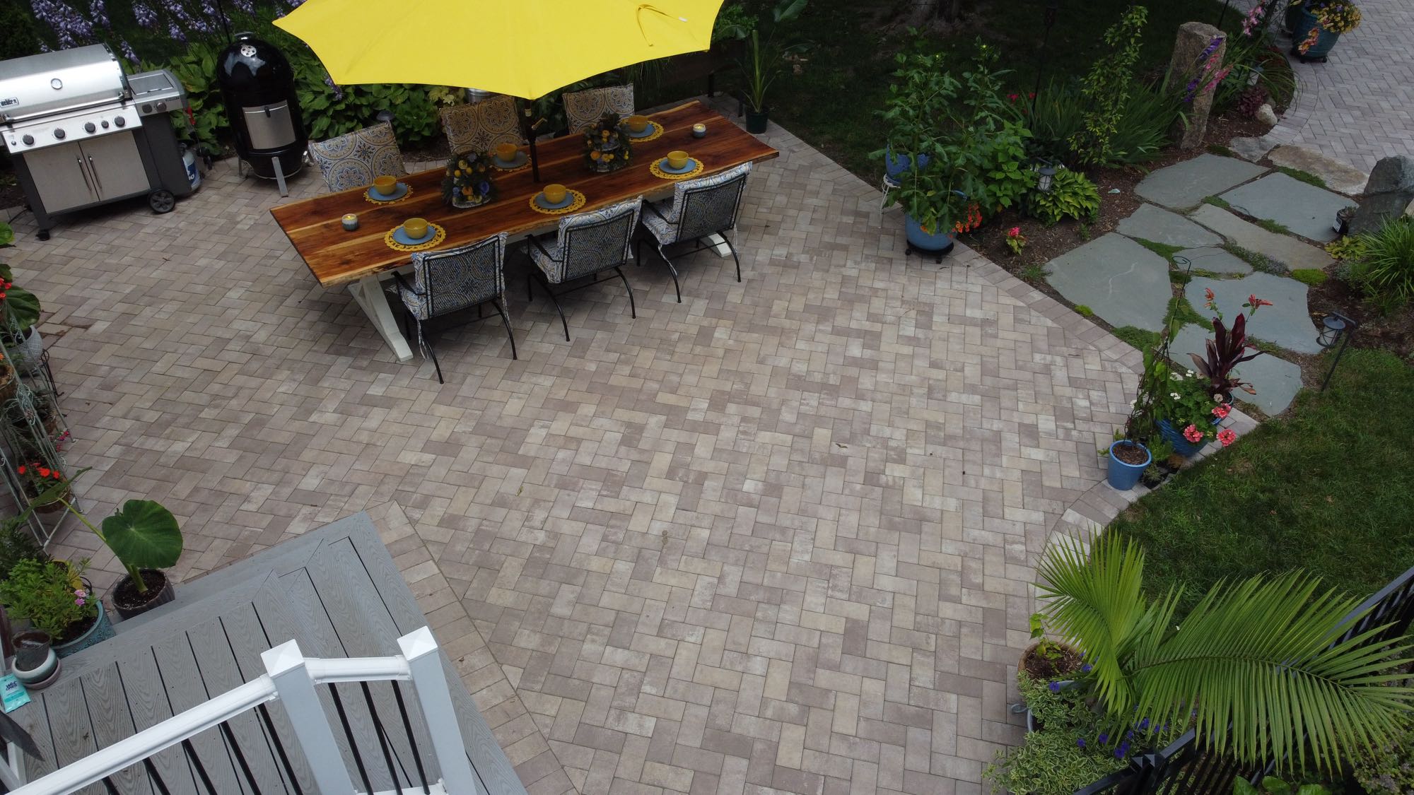 Arnold Ave project; paver patio and natural stone walkway with grill and dining set