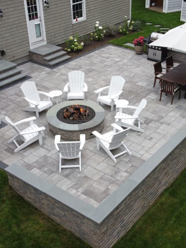 Half Mile road project; small paver patio with stone wall and two stone stairs to back doors