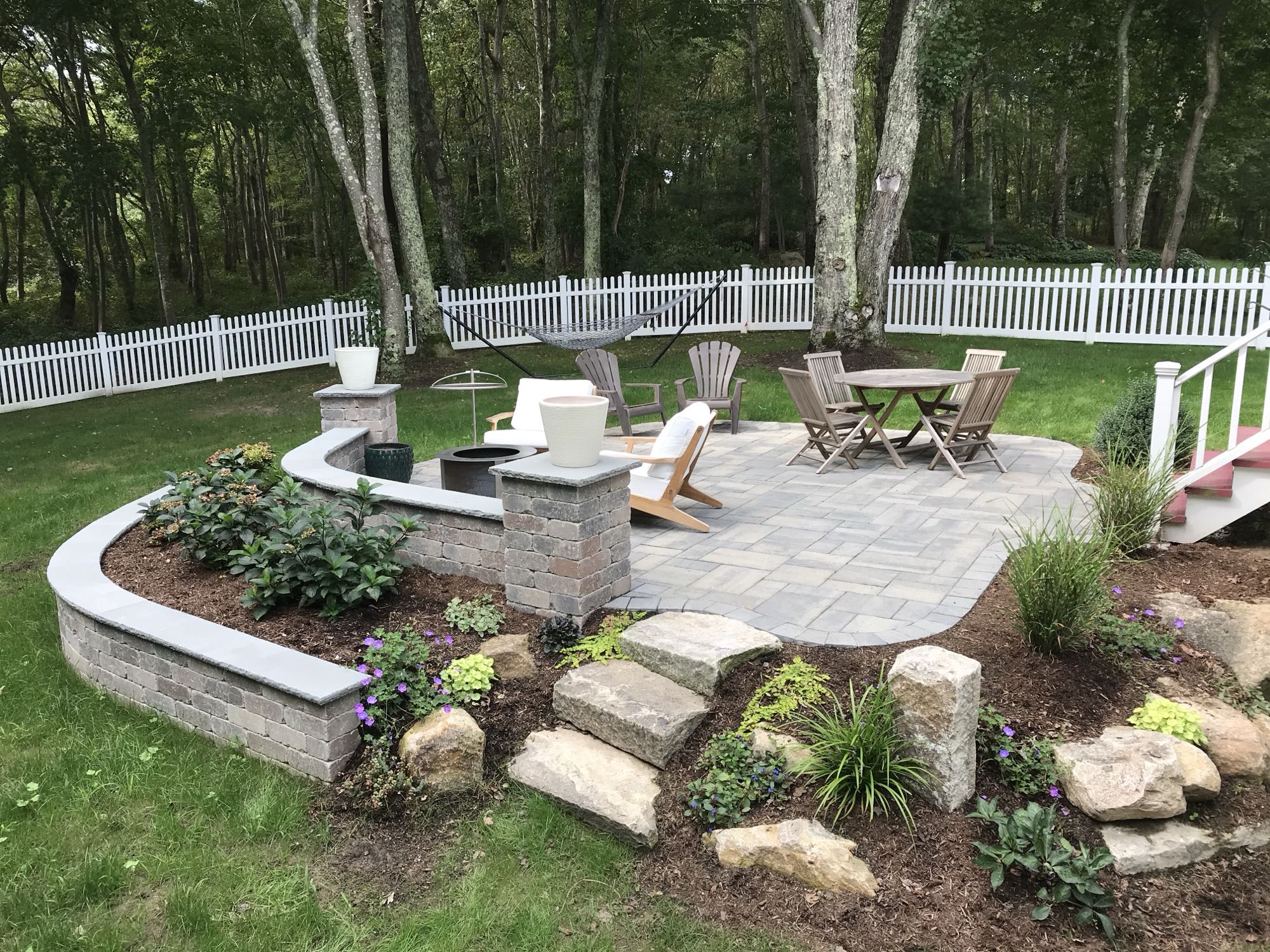 Prides Crossing project; small paver patio and natural stone stairs with multi-level landscaping