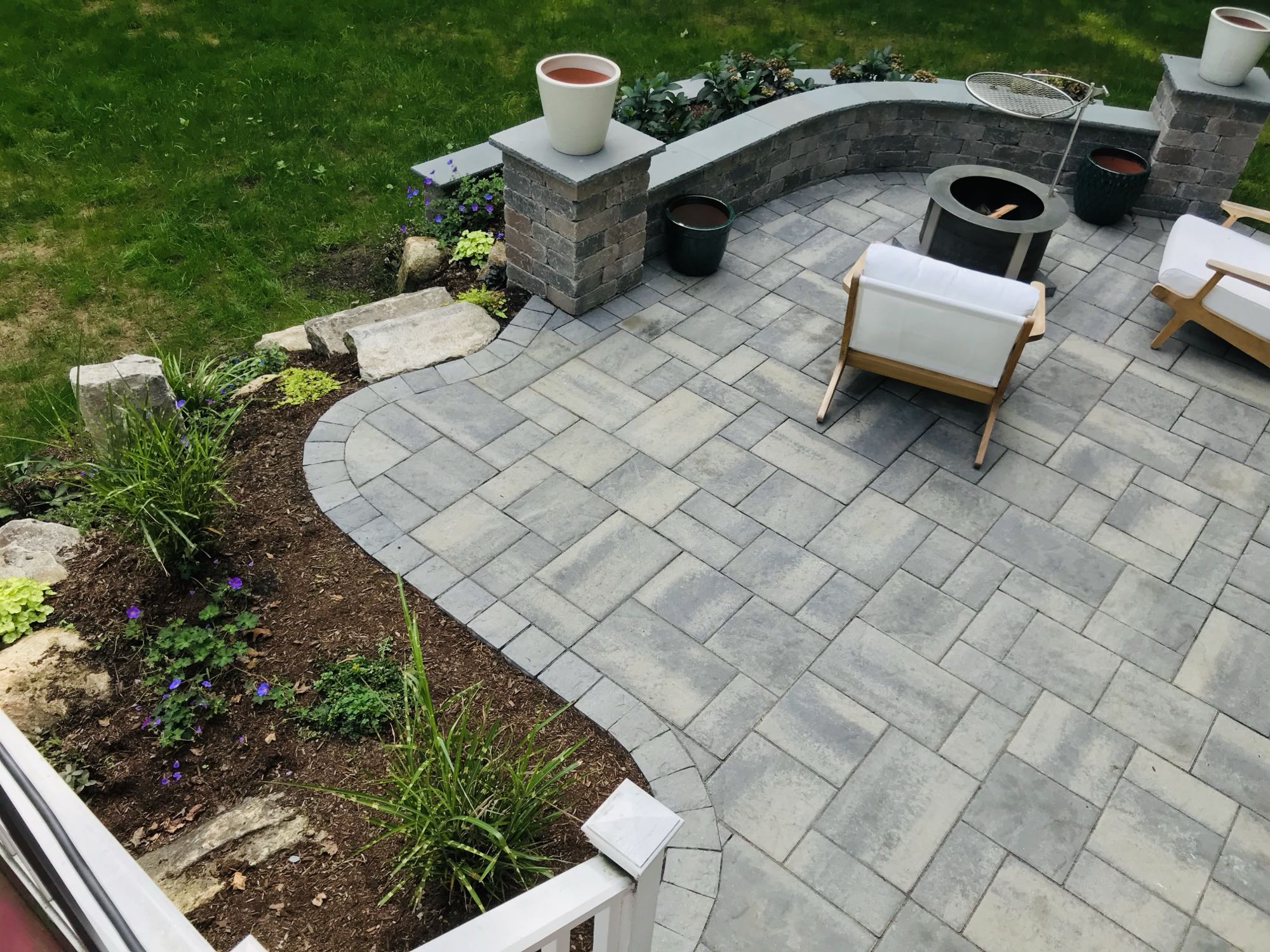 Prides Crossing project; small paver patio and natural stone stairs with multi-level landscaping