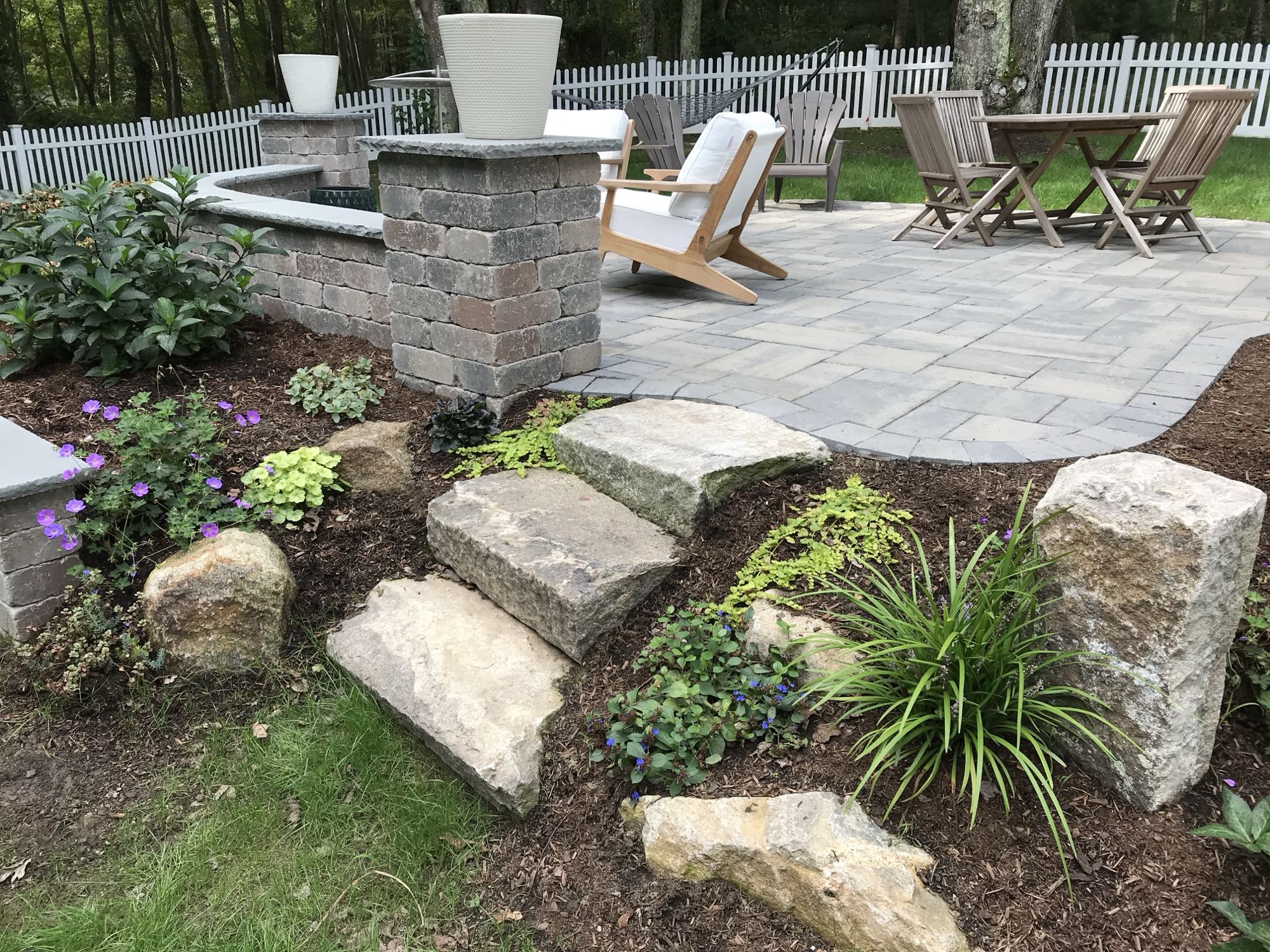 Prides Crossing project; small paver patio and natural stone stairs with multi-level landscaping