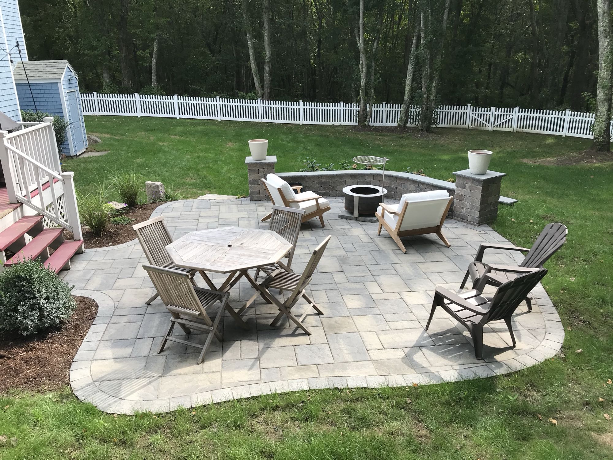 Prides Crossing project; small paver patio with fire pit area and dining set