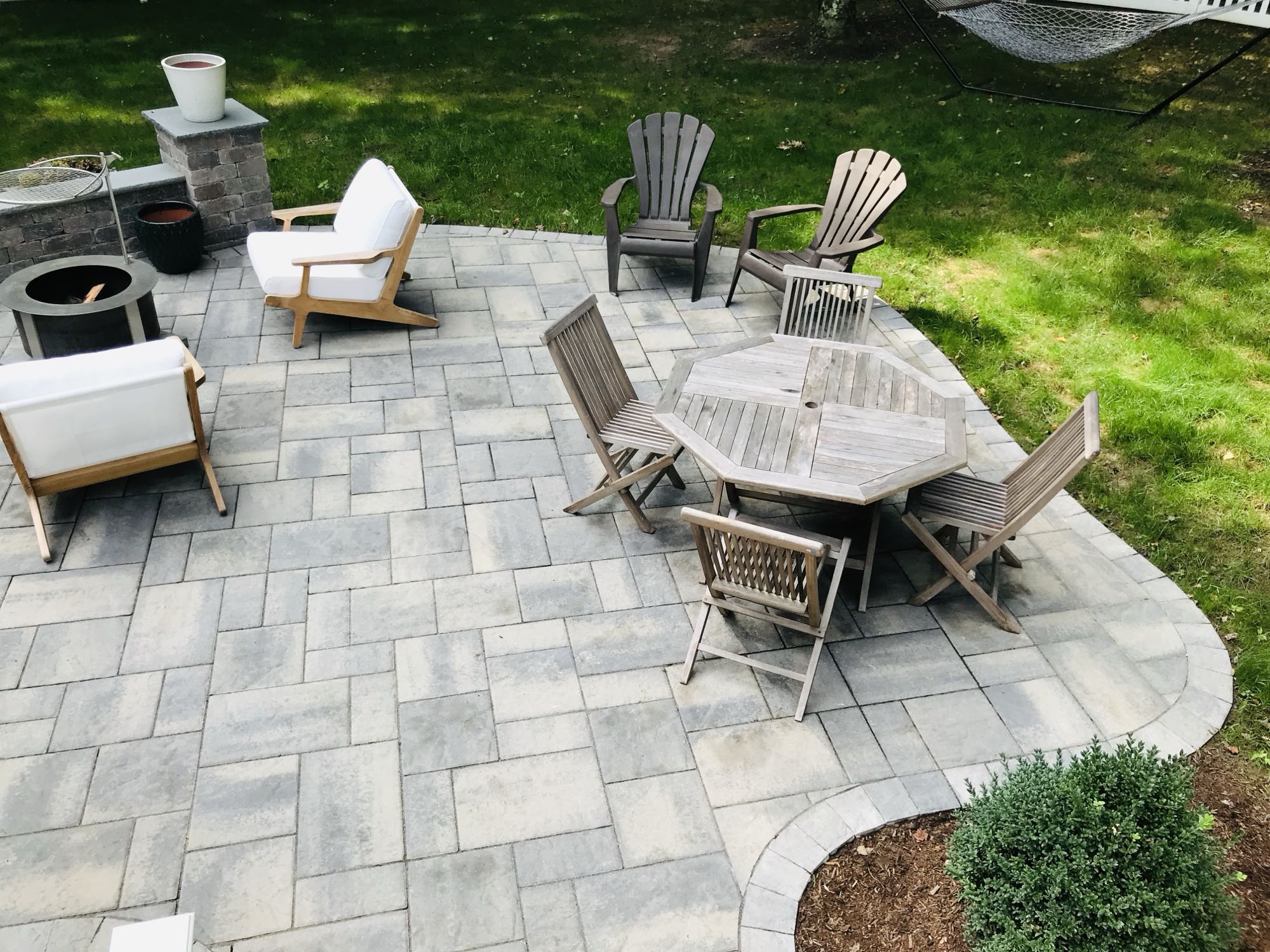 Prides Crossing project; small paver patio with fire pit area and dining set