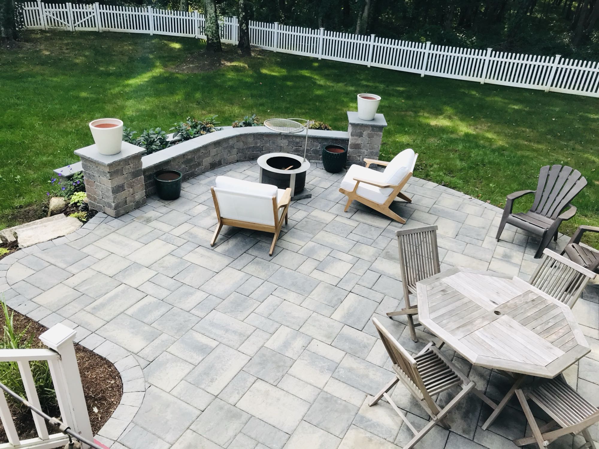 Prides Crossing project; small paver patio with fire pit area and dining set