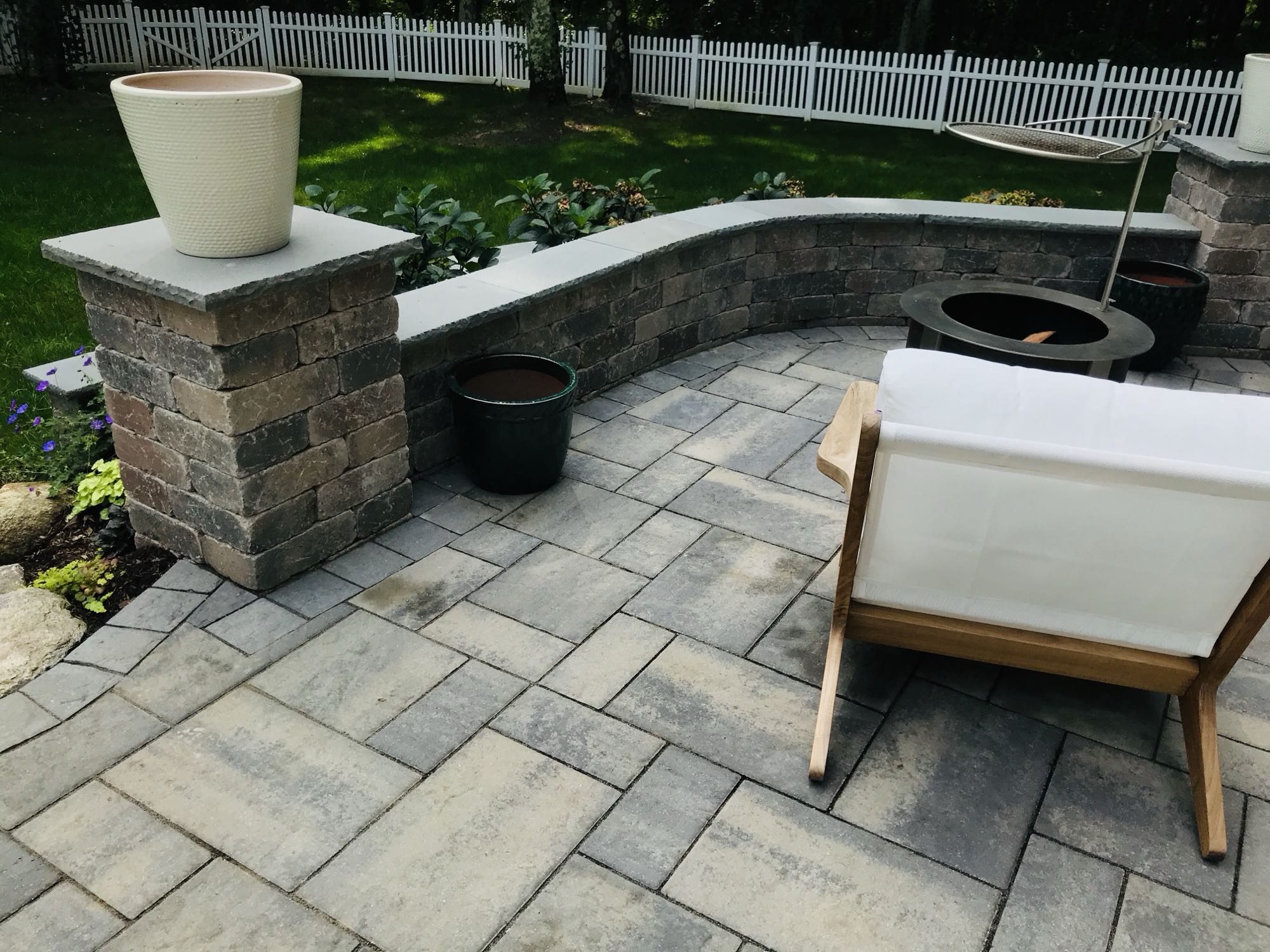 Prides Crossing project; small paver patio with stone wall