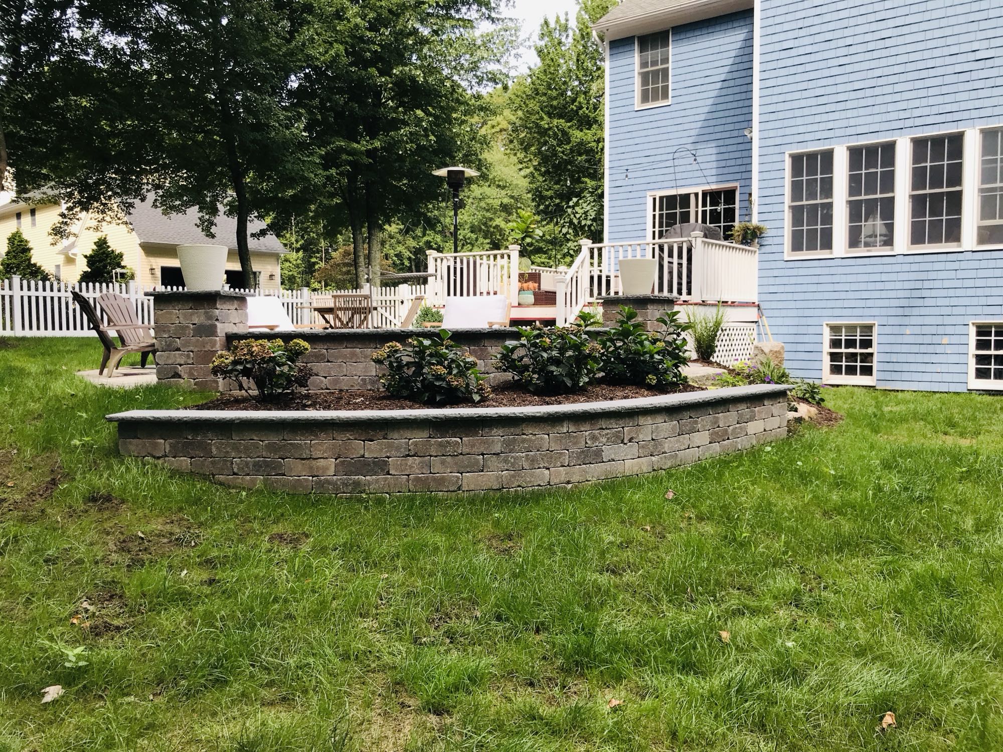 Prides Crossing project; stone retaining walls with multi-level landscaping