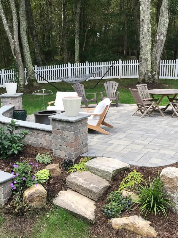 Prides Crossing project; small paver patio and natural stone stairs with multi-level landscaping