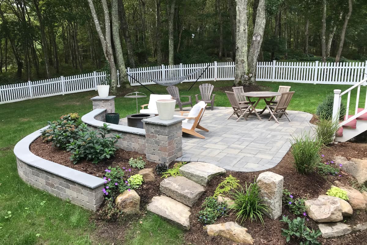 Prides Crossing project; small paver patio and natural stone stairs with multi-level landscaping