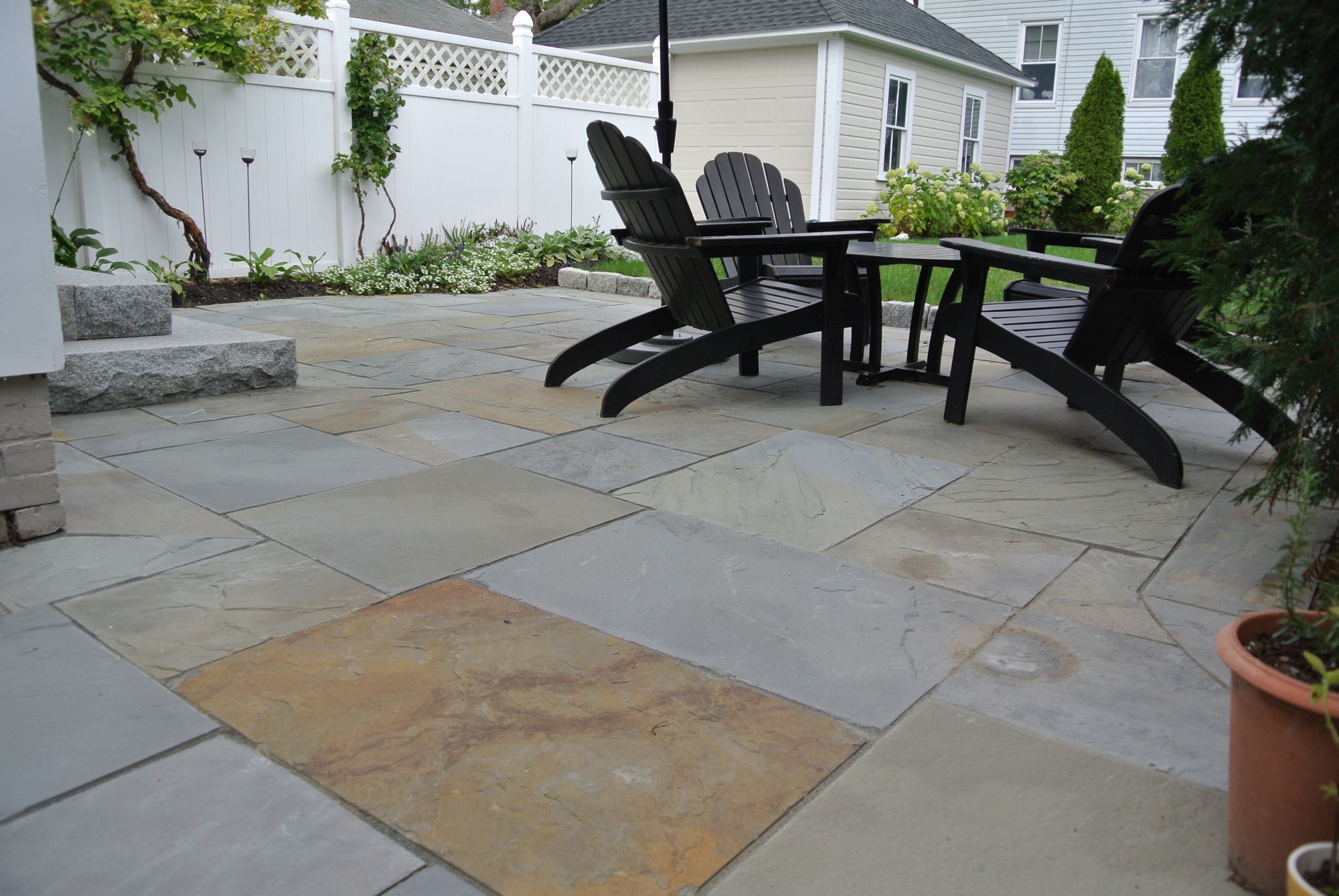 Prospect Street project; natural stone patio with Adirondack chairs