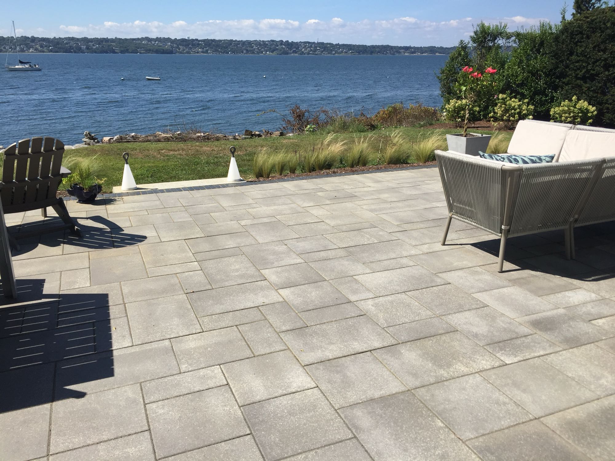 Sapowet patio project; view of small paver patio overlooking bright blue lake