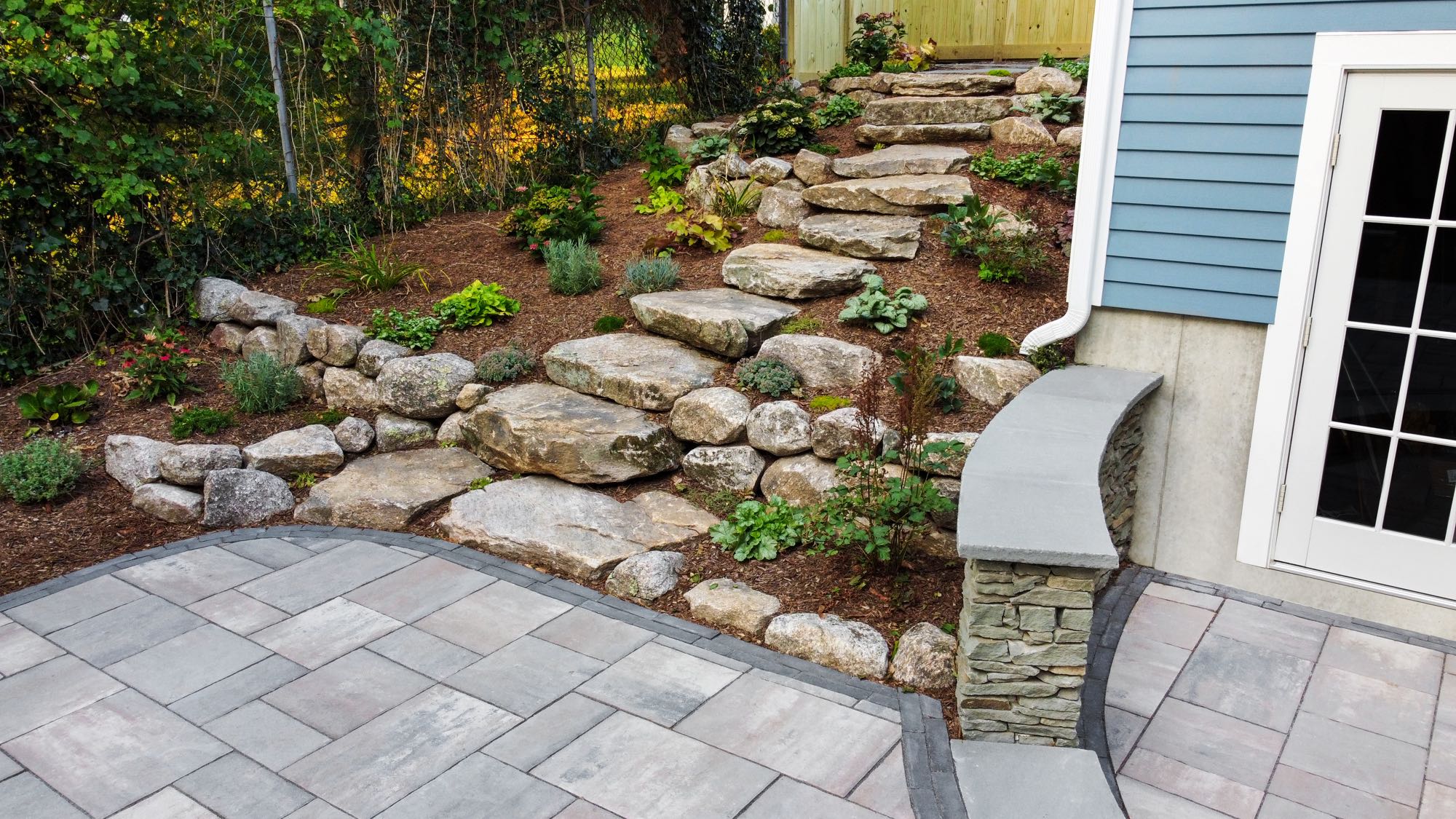 Wolcott Ave project; paver patio with landscaped natural stone stair walkway