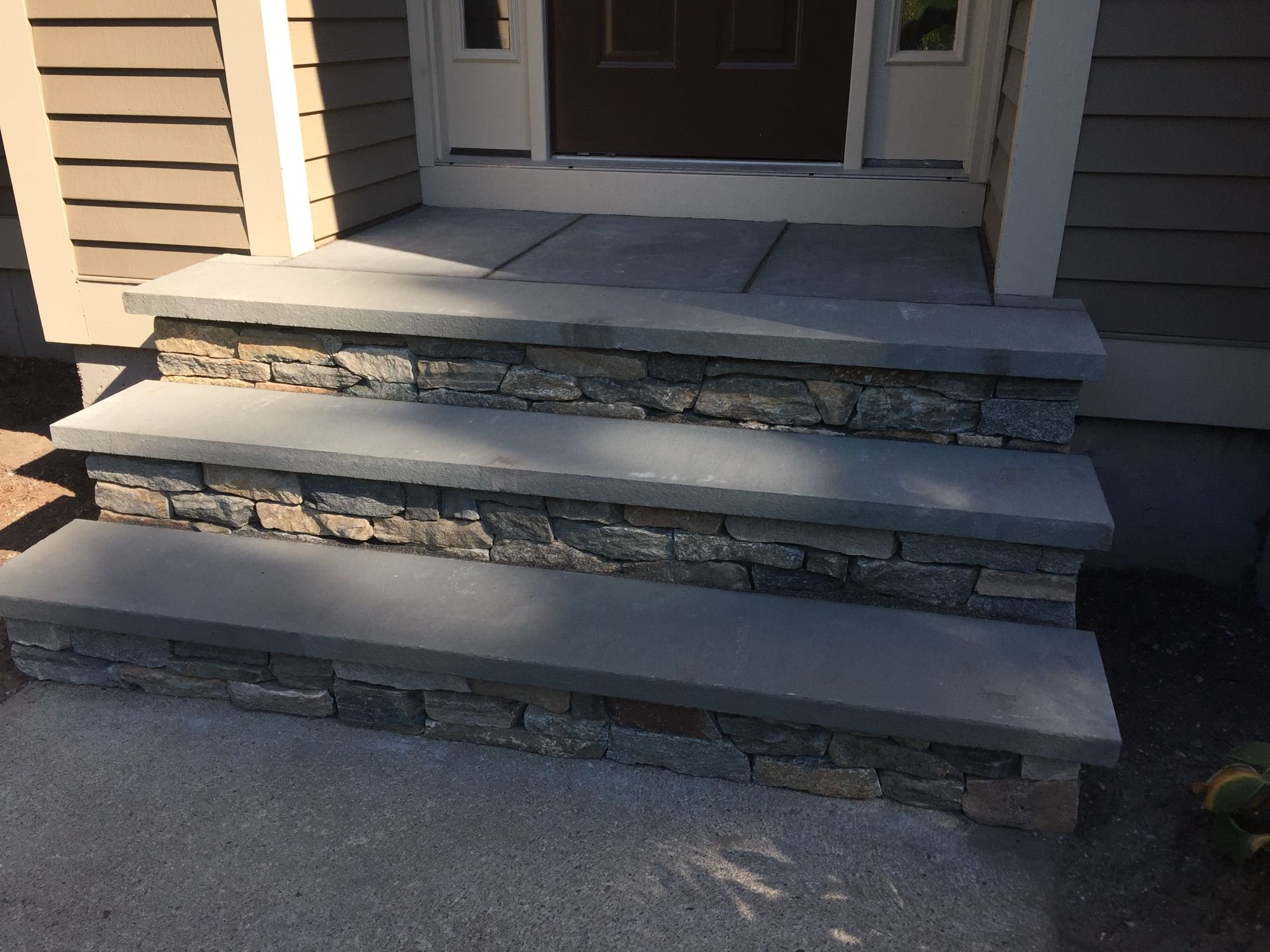 Sage Trails project; stone stairs leading to a stone porch and front door