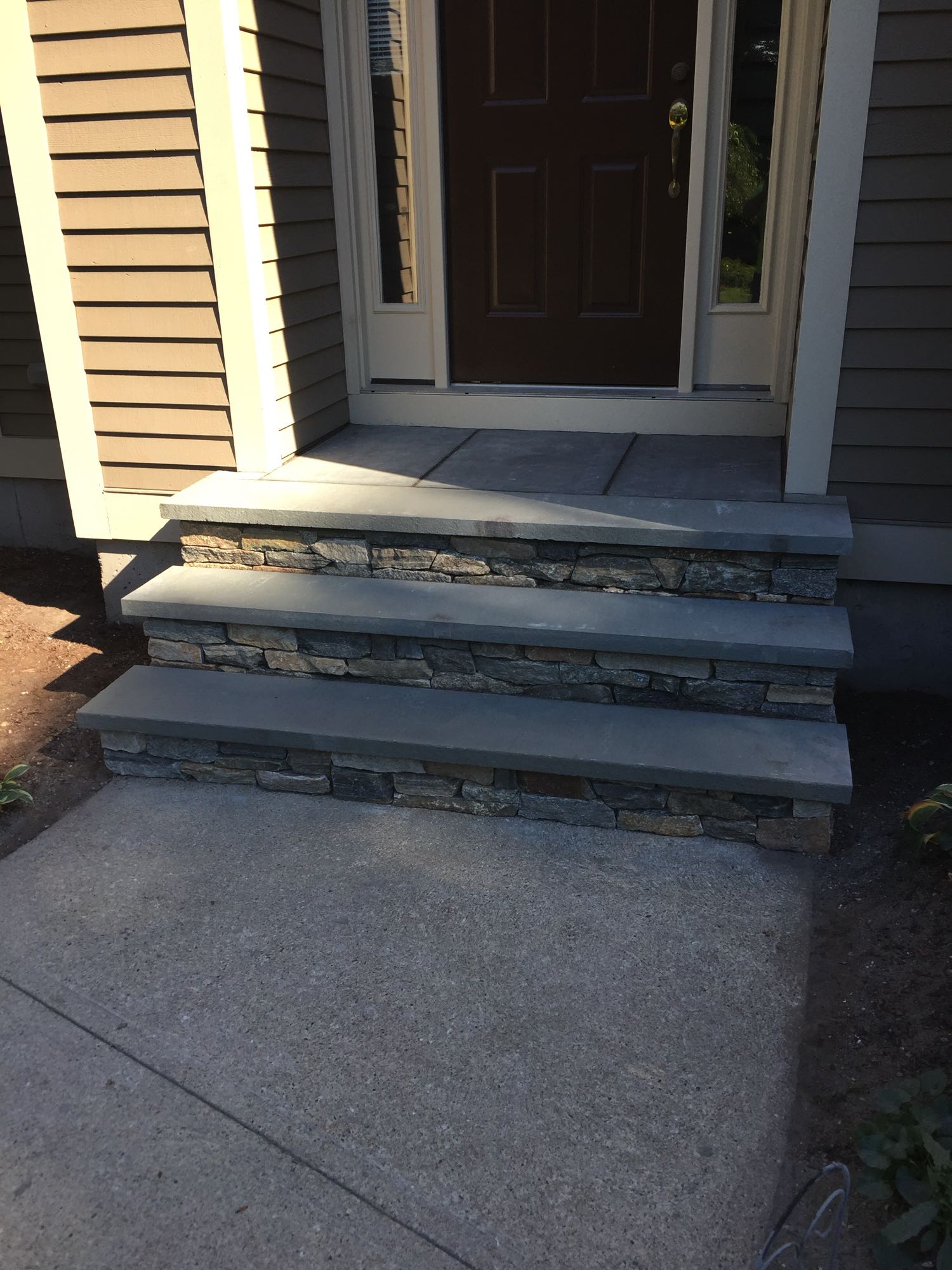 Sage Trails project; stone stairs leading to a stone porch and front door