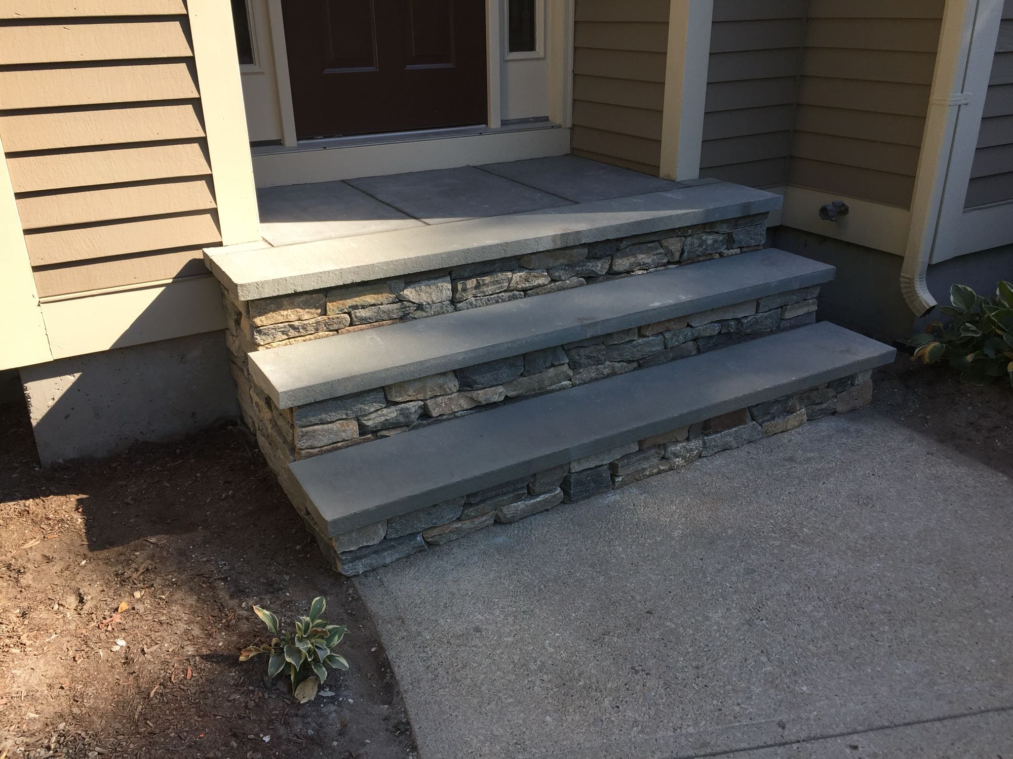 Sage Trails project; stone stairs leading to a stone porch and front door