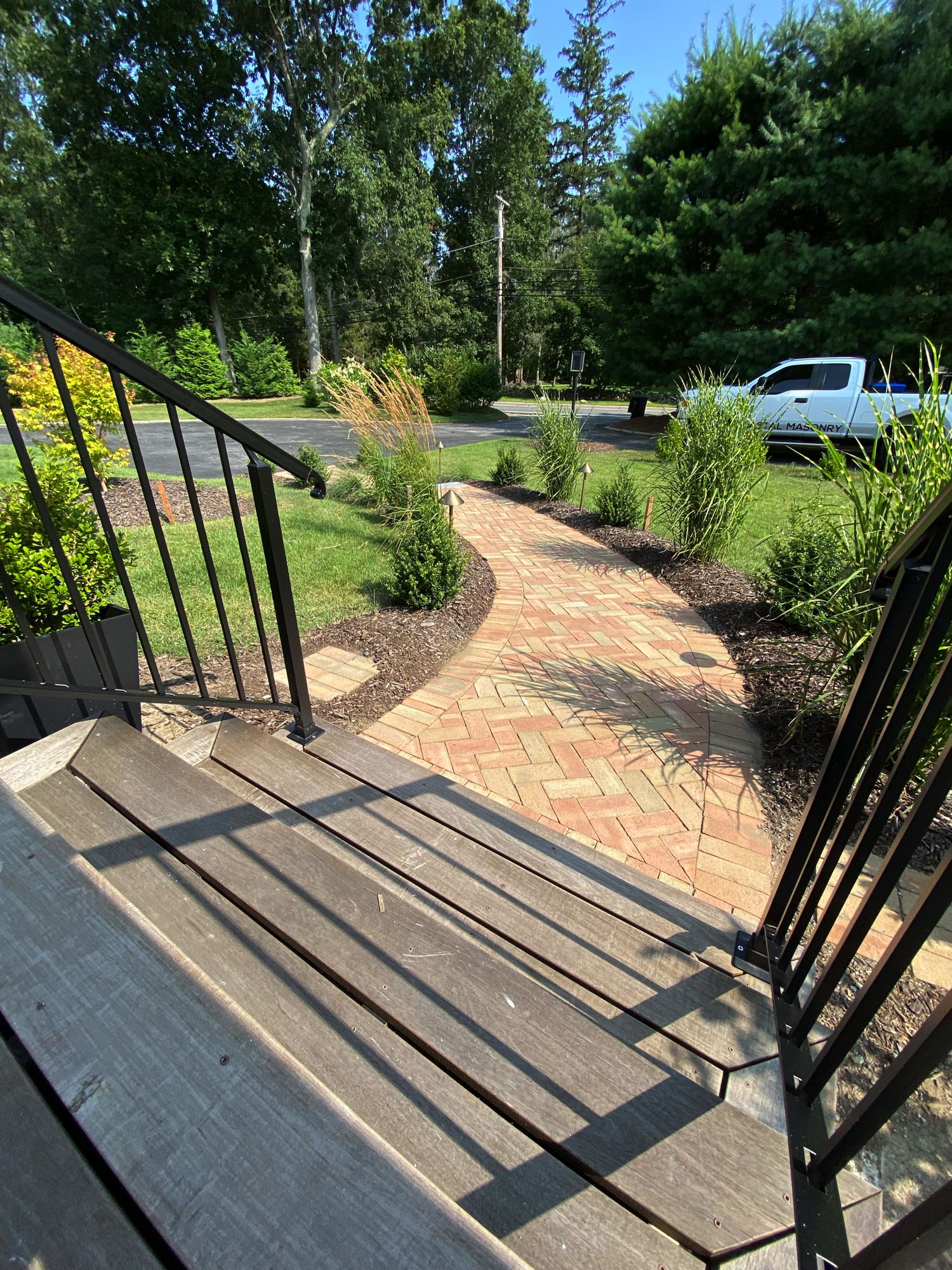 Division Rd project; view of brick paver walkway in herringbone pattern from front steps of house