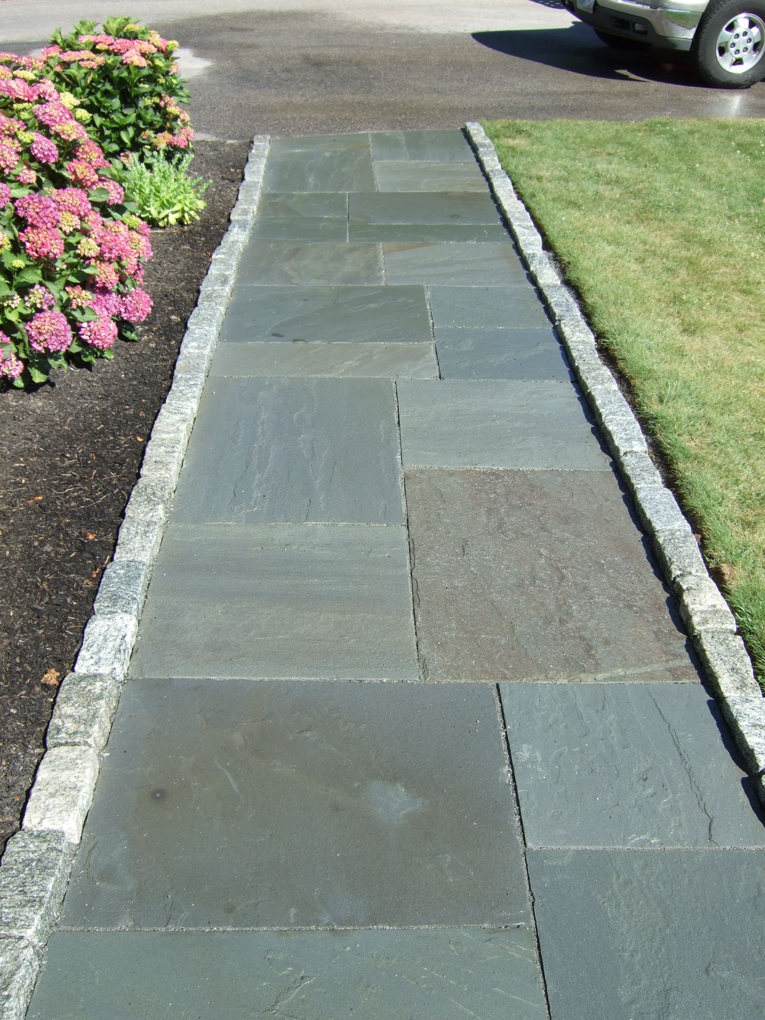 Great Island project; natural stone walkway bordered by stone bricks