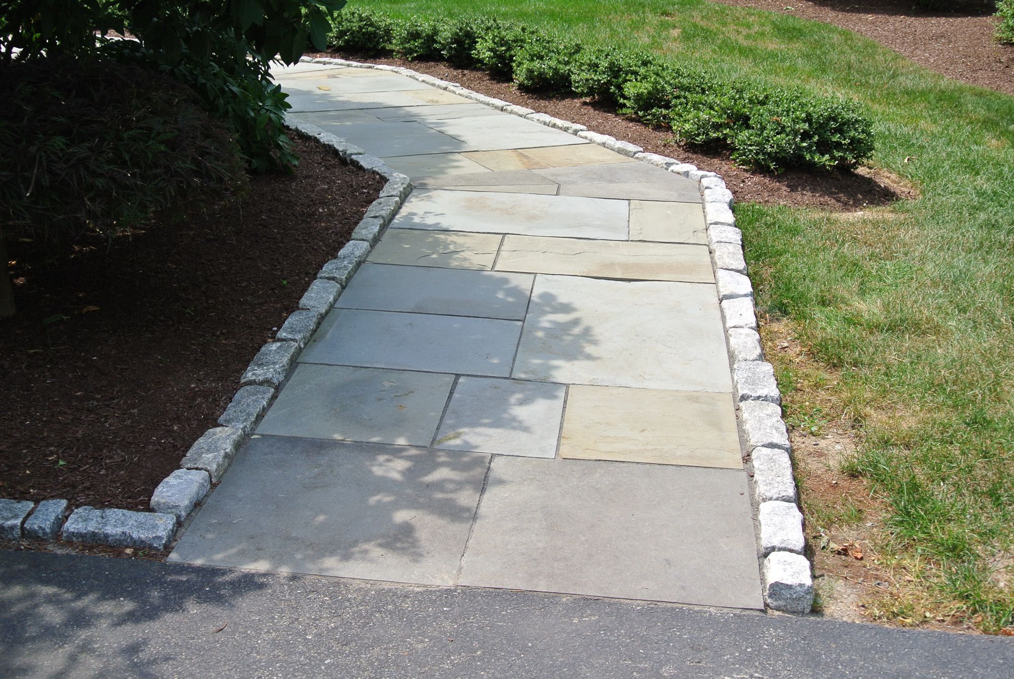 Larkspur project; natural stone walkway bordered by stone bricks