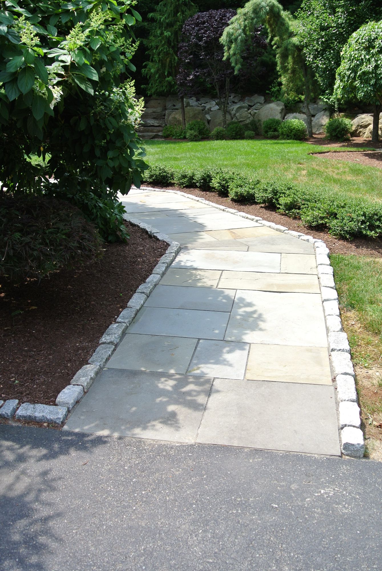 Larkspur project; natural stone walkway bordered by stone bricks