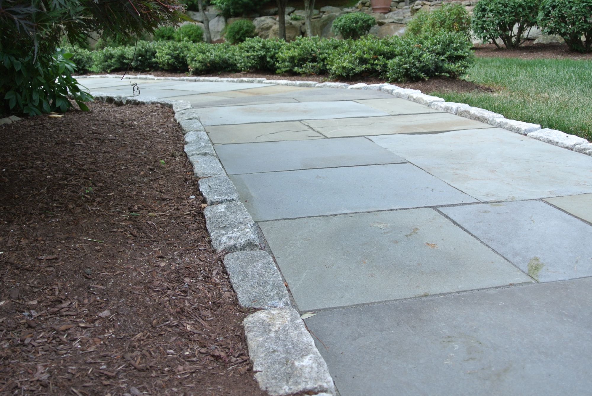 Larkspur project; natural stone walkway bordered by stone bricks