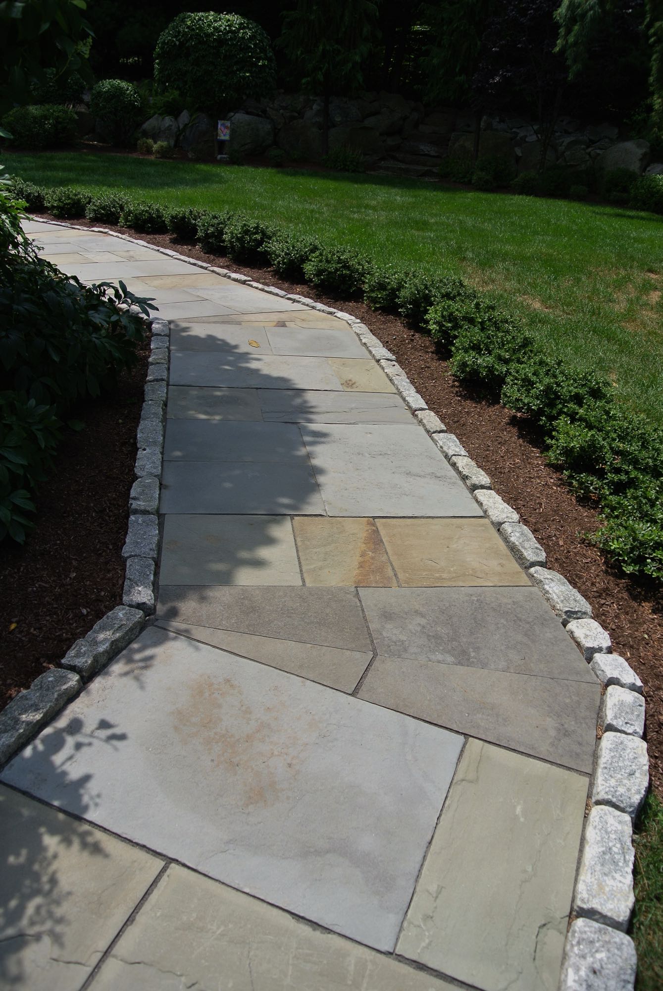 Larkspur project; natural stone walkway bordered by stone bricks