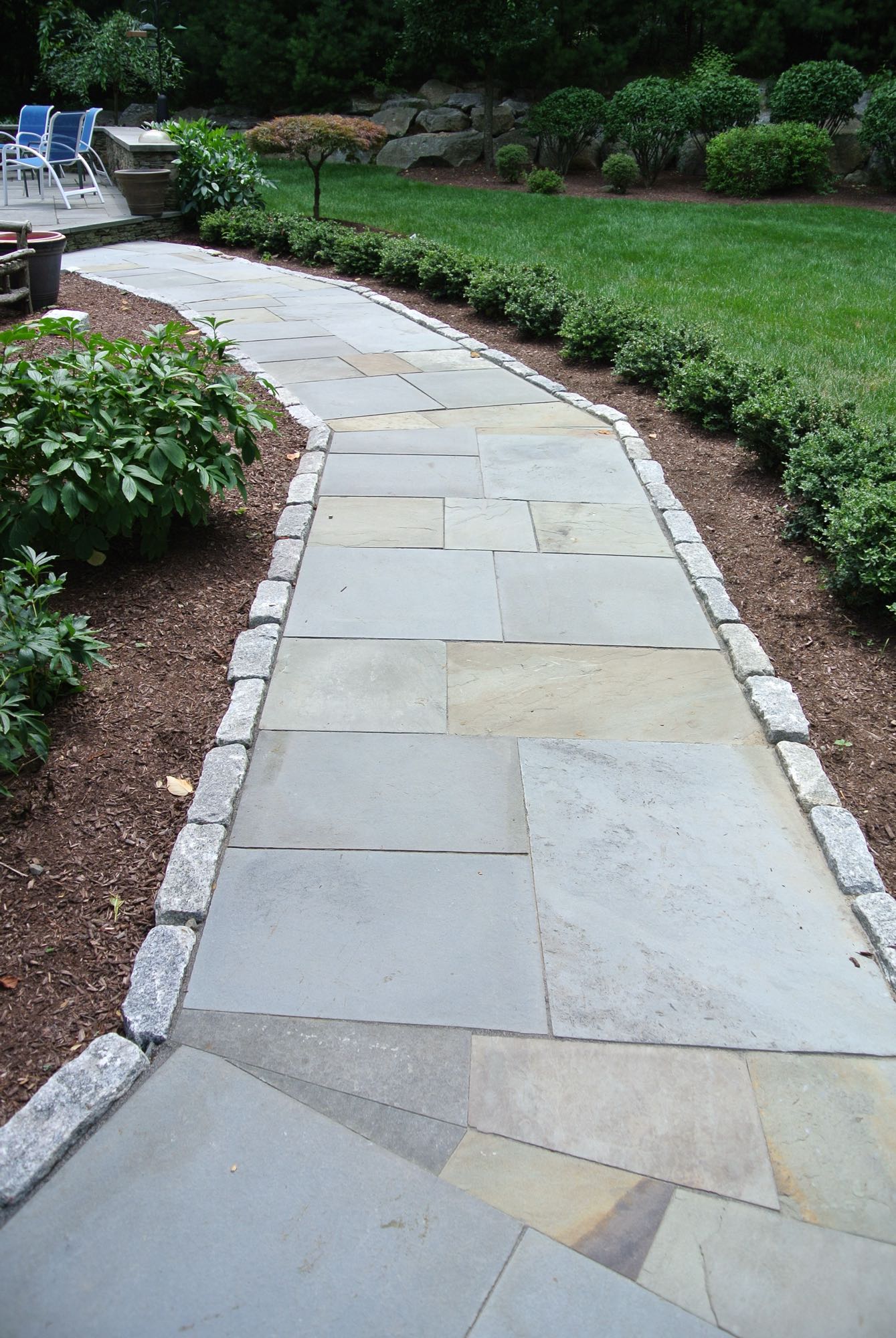 Larkspur project; natural stone walkway bordered by stone bricks