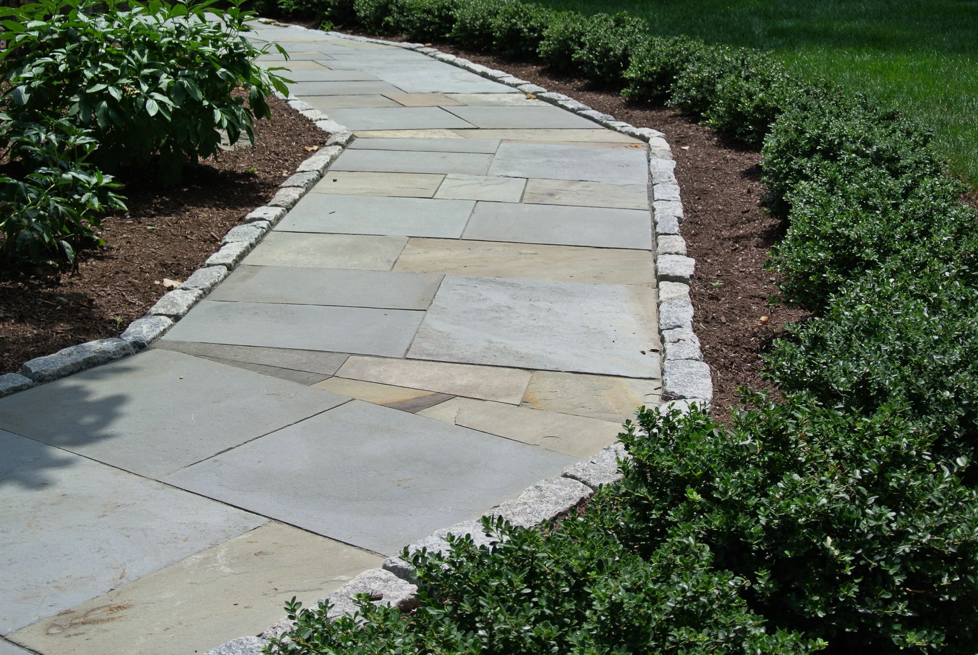 Larkspur project; natural stone walkway bordered by stone bricks