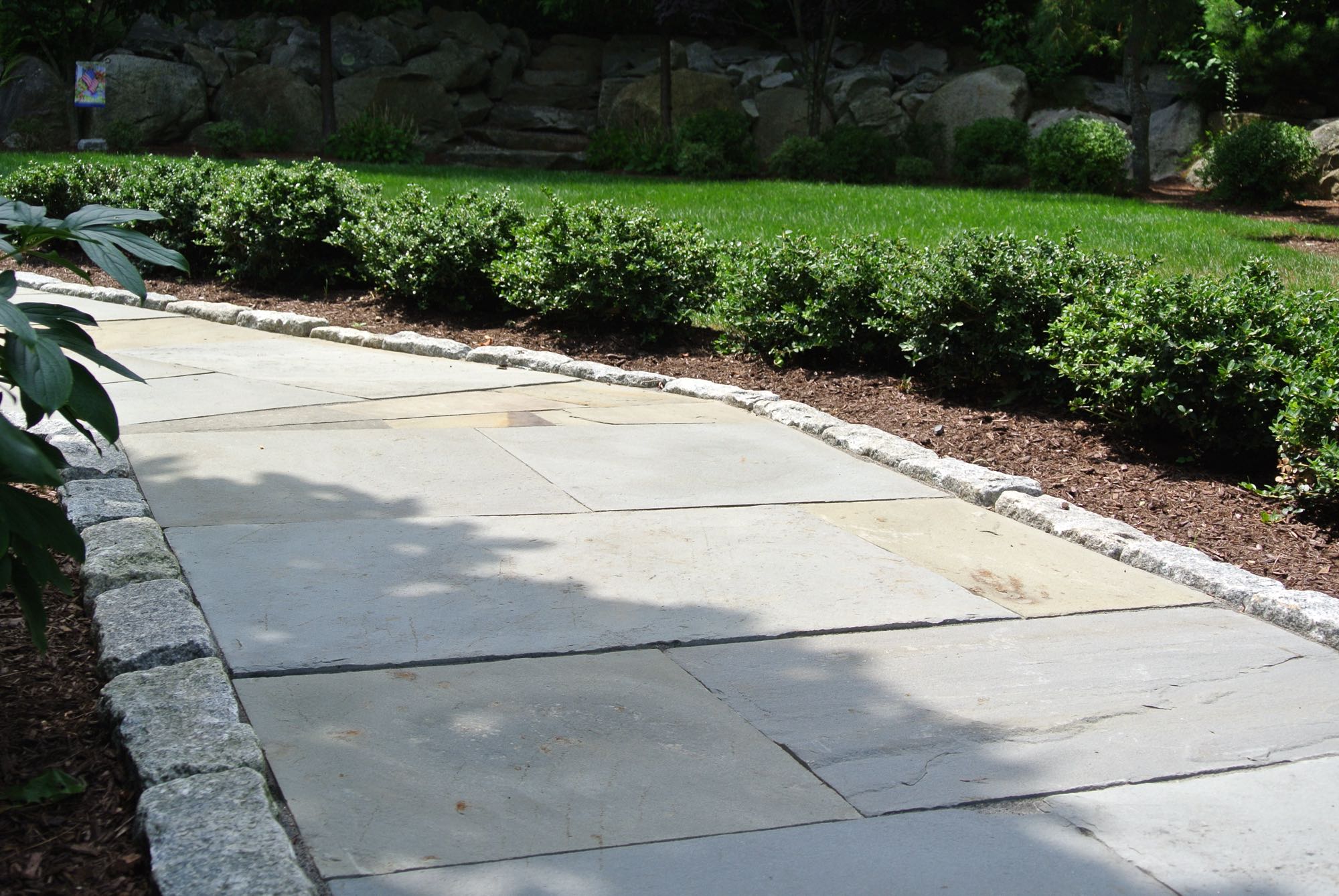 Larkspur project; natural stone walkway bordered by stone bricks