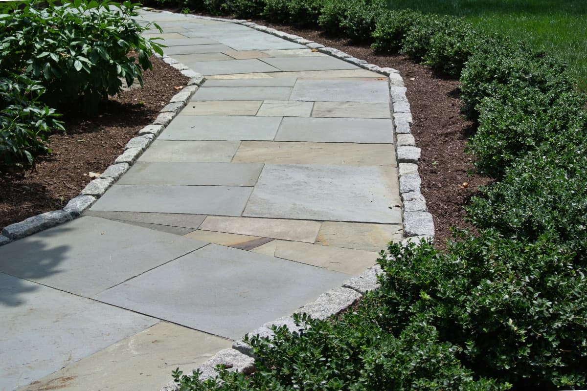 Larkspur project; natural stone walkway bordered by stone bricks