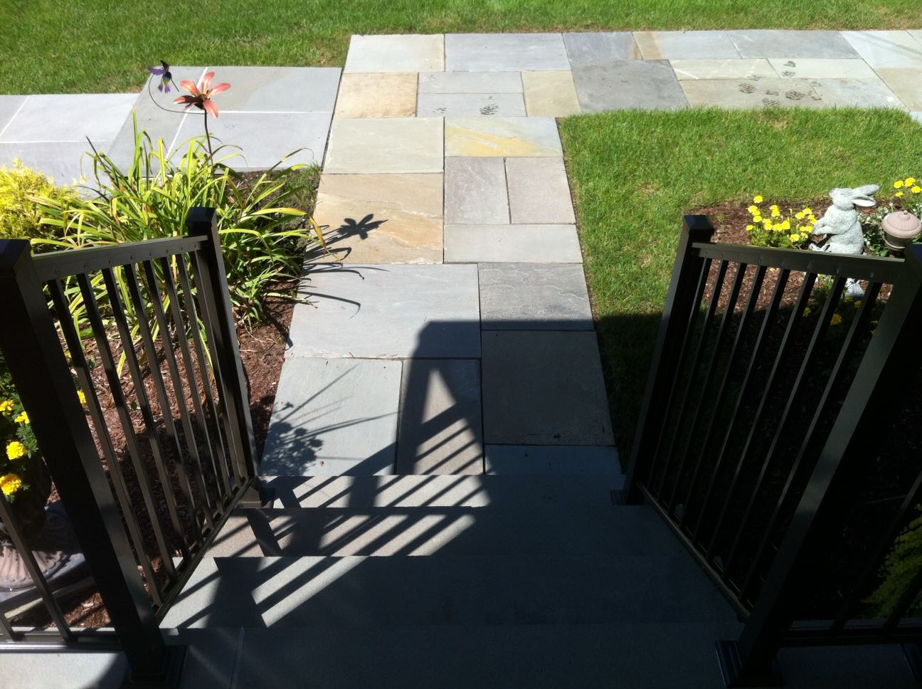 North Providence project; natural stone walkway, front porch stairs, and walkway stairs leading down to driveway