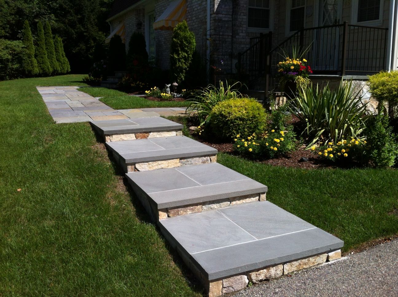 North Providence project; natural stone walkway and walkway stairs leading down to driveway