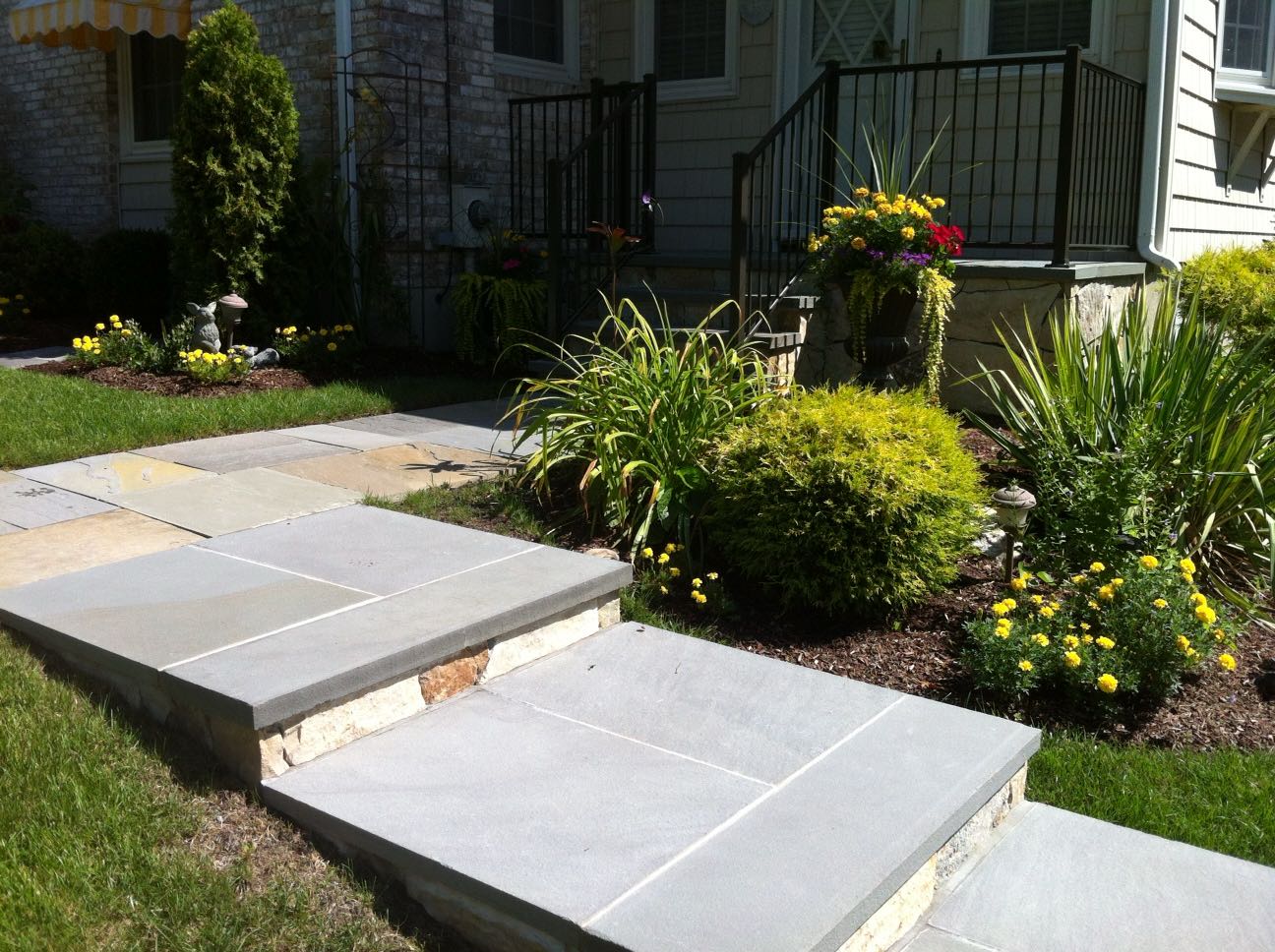 North Providence project; natural stone walkway, front porch stairs, and walkway stairs leading down to driveway