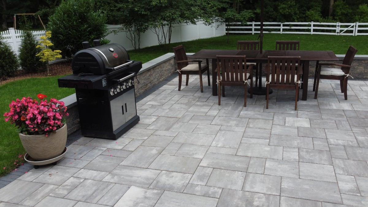 stone patio with grill and dining set