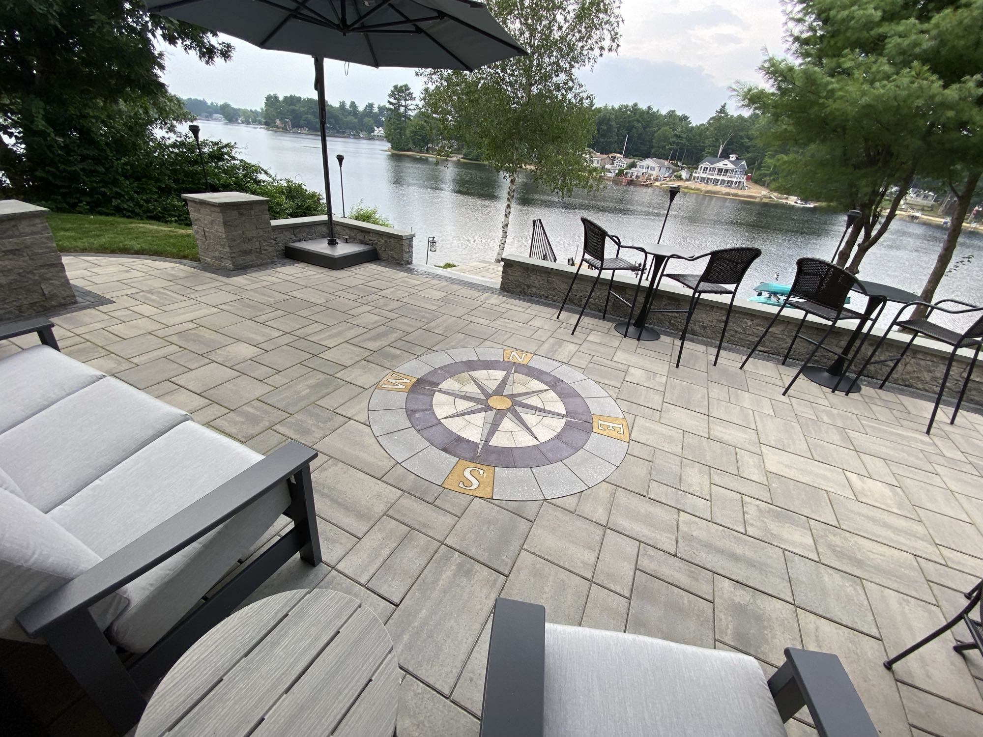 paver stone patio with compass design overlooking lake