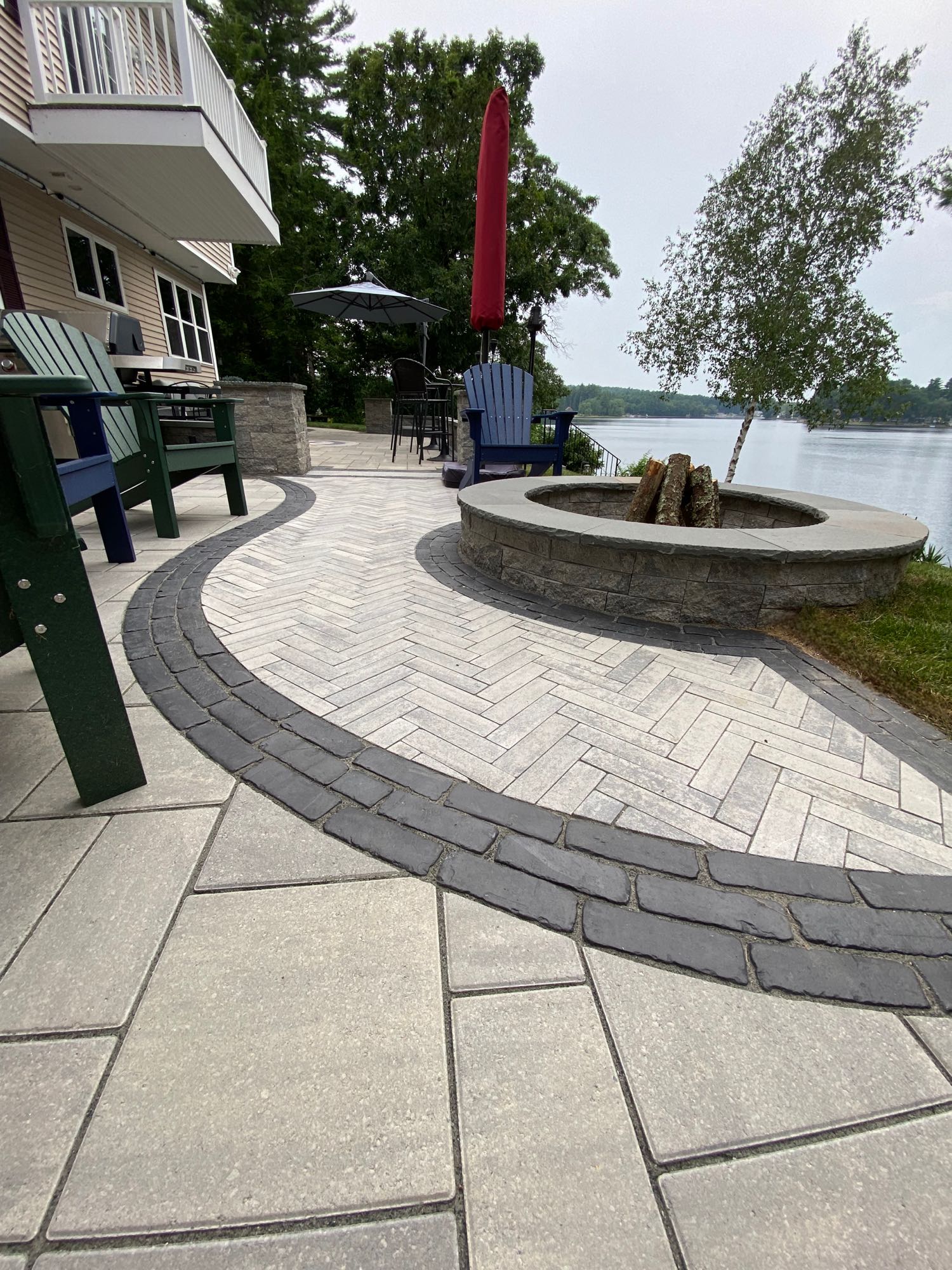 paver stone patio with multiple patterns and a paver fire pit