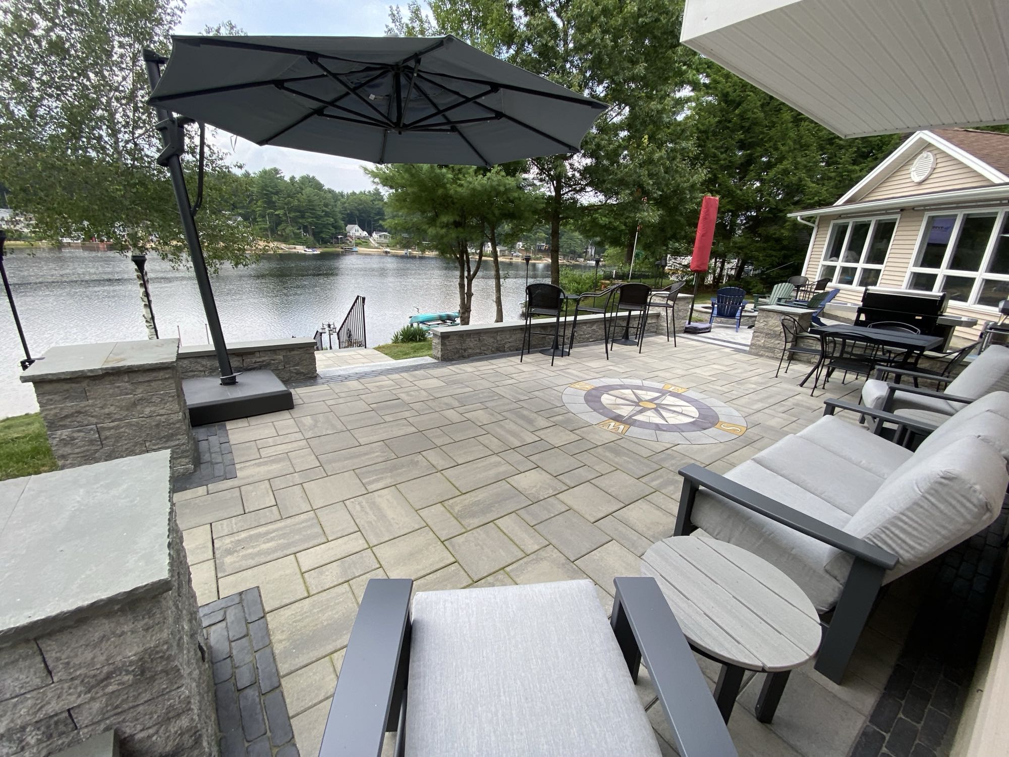 paver stone patio with compass design overlooking lake