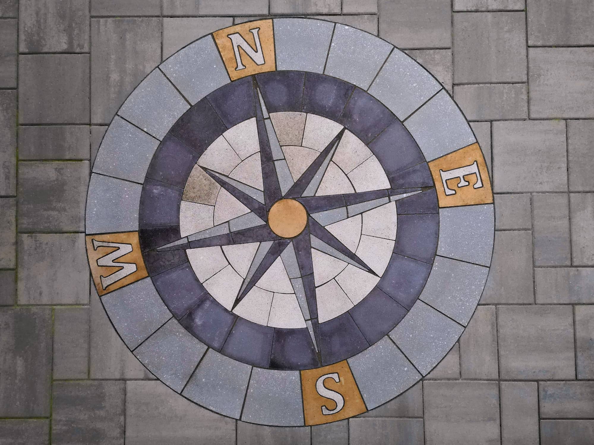 compass made out of paver stones on patio