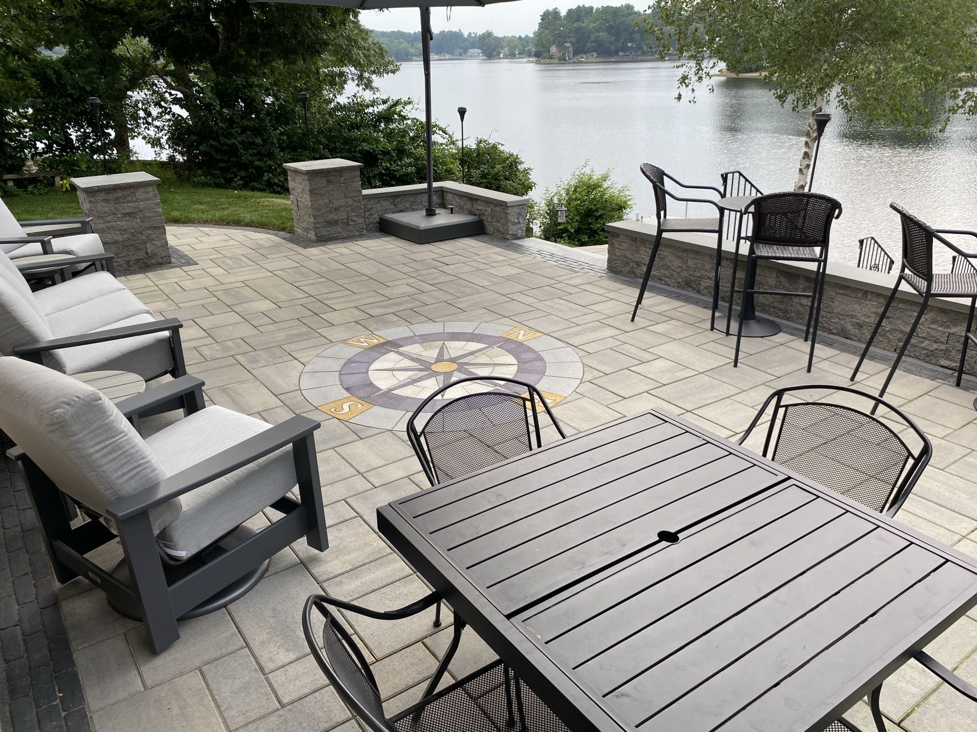 paver stone patio with compass design overlooking lake