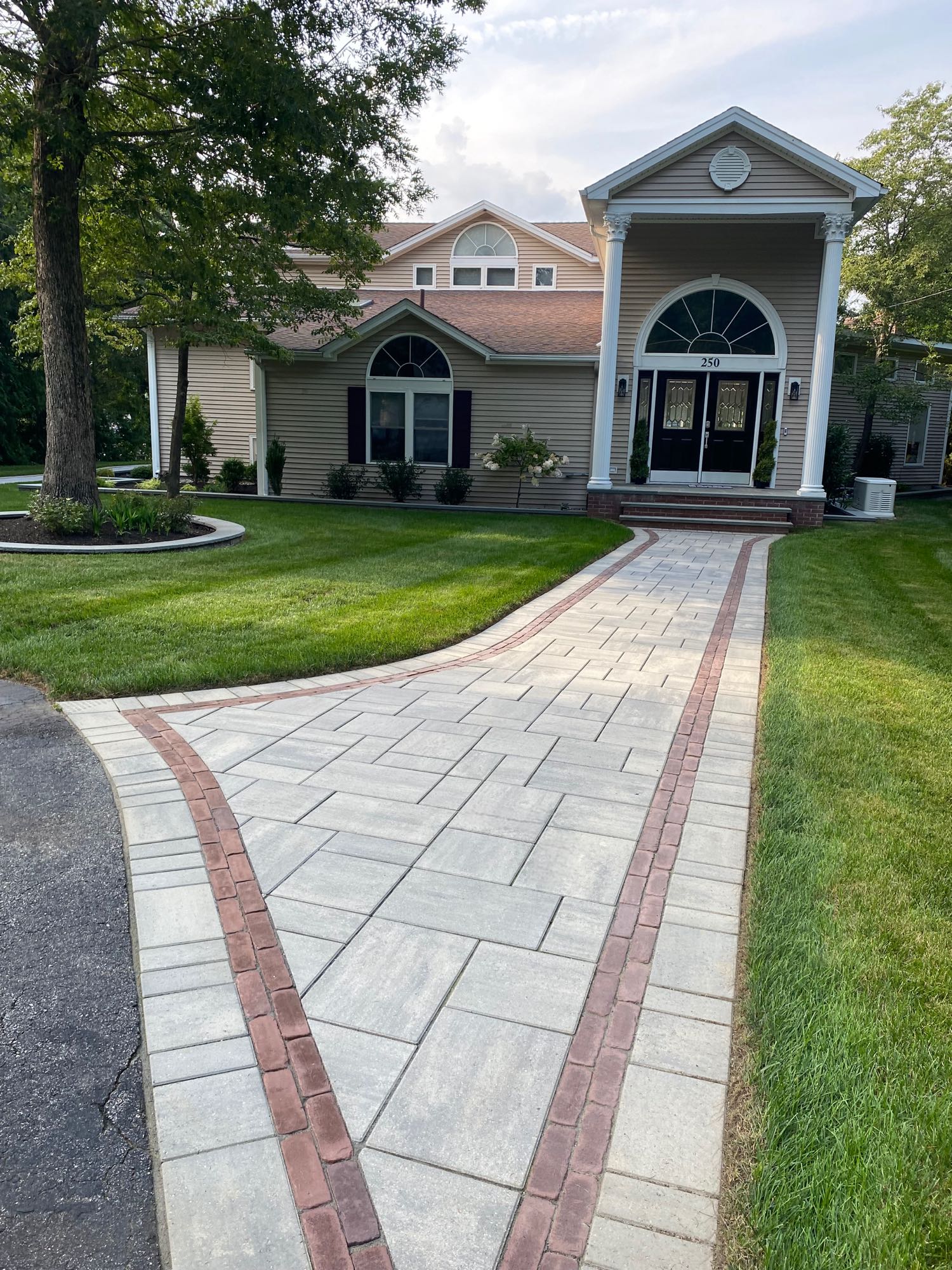 paver walkways with border pattern leading to front door