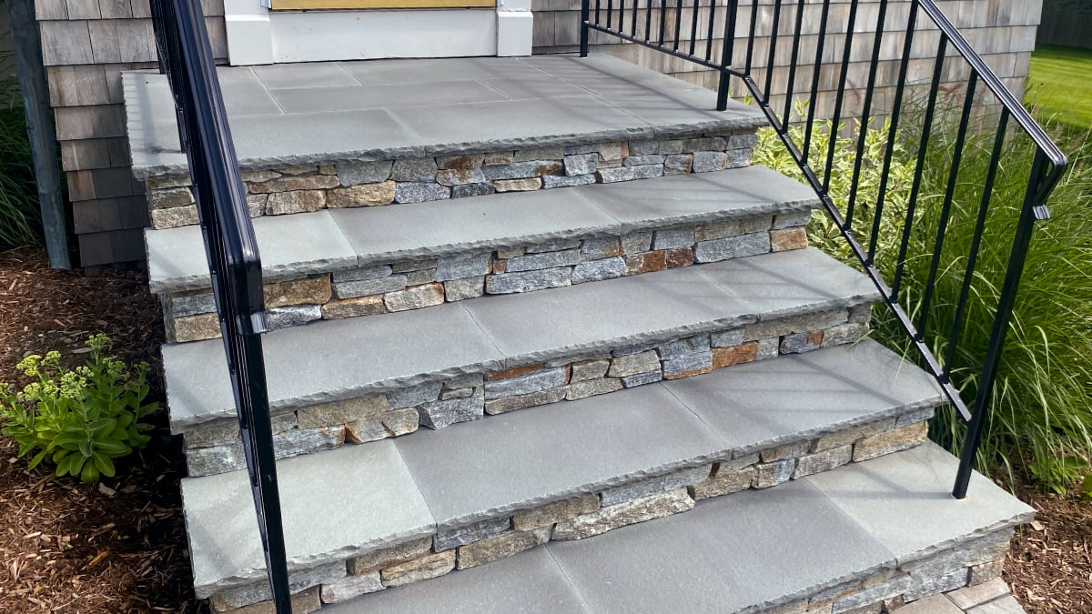 natural stone steps and porch leading to front door