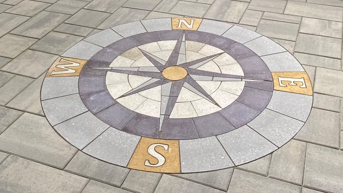 compass made out of paver stones on patio