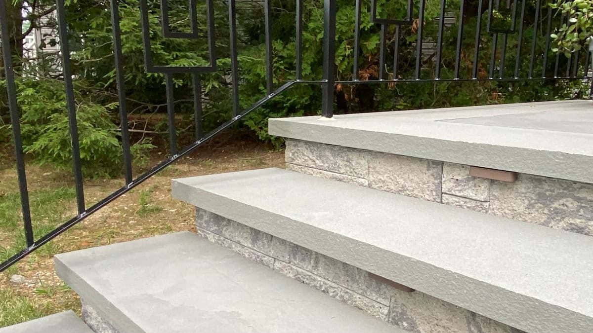 paver stair steps with black metal railing