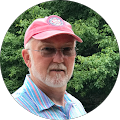 older man with red hat, thin rimmed glasses and white facial hair